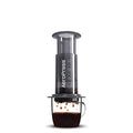 Aerpress portable coffee maker on a cup of coffee