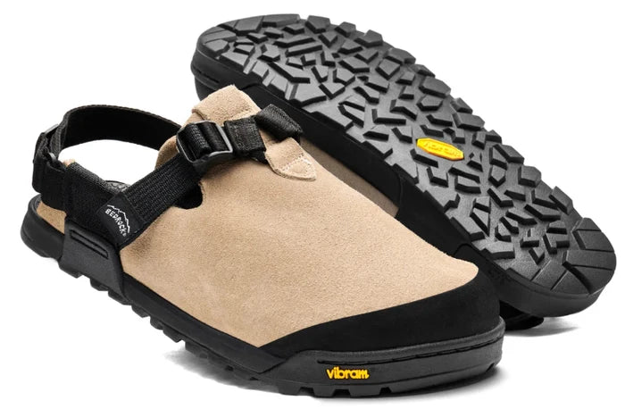 Beige sandals with black straps and sole on a white background