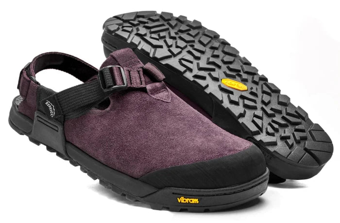 Purple clog shoe with black sole and Vibram branding on a white background