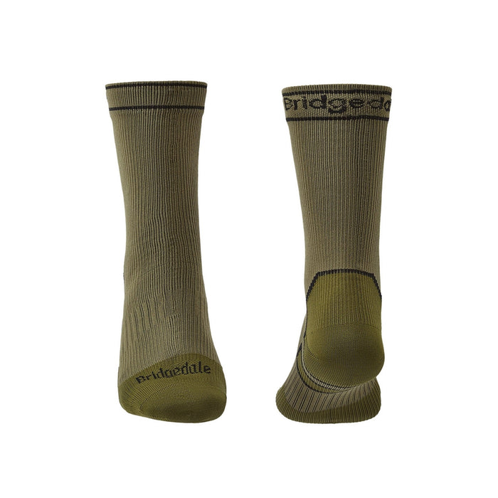 A pair of Bridgedale Storm Sock Midweight Boots in beige color, featuring a terry pad footbed and branded with 'bridgedale.com' on the ankle area.
