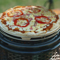 Pizza with tomato slices on a grill