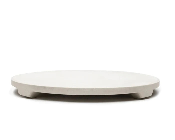 Round white stone slab for pizza making on a white background