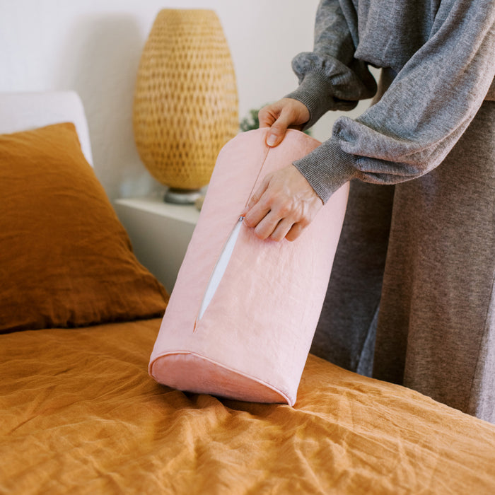 a lady zipping bolster pillow with evening rose cover