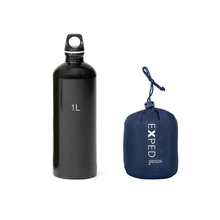Black water bottle labeled '1L' and blue EXPED pillow on a white background