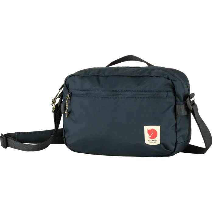Navy blue shoulder bag with a visible brand logo on a white background