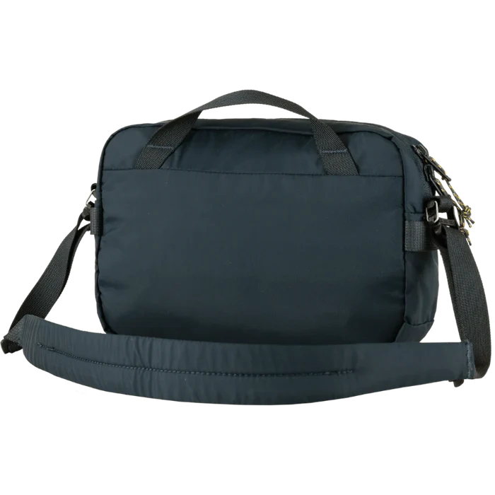 Navy blue bag with a shoulder strap on a white background