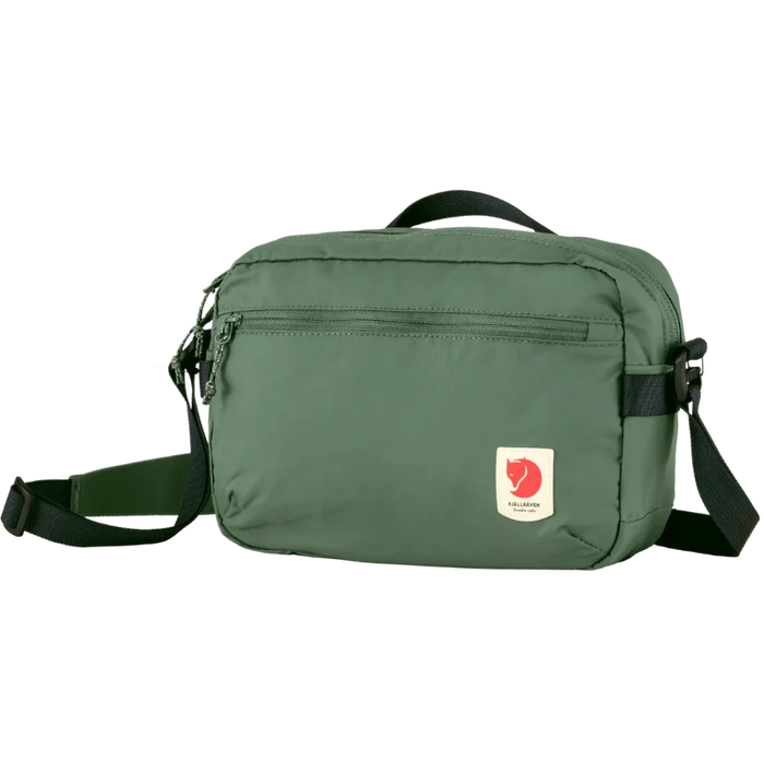 Green shoulder bag with a visible brand logo on a white background