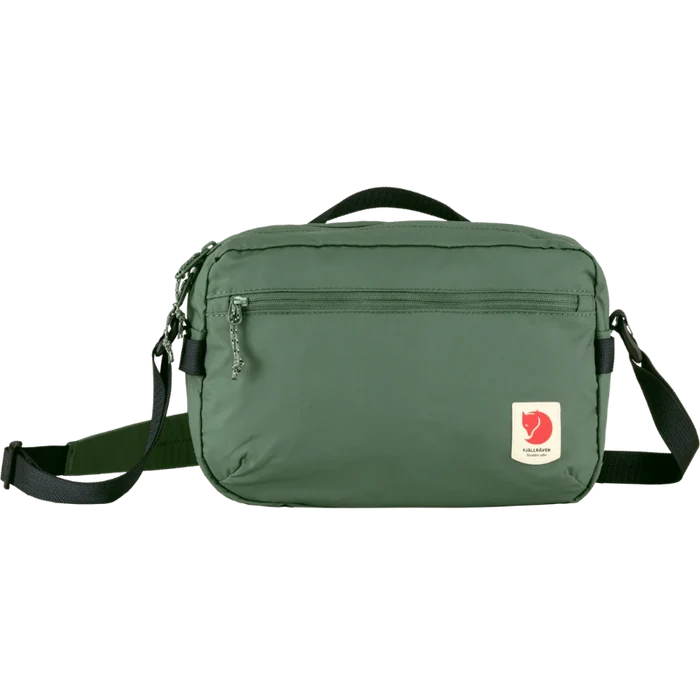 Green shoulder bag with a visible brand logo on a white background