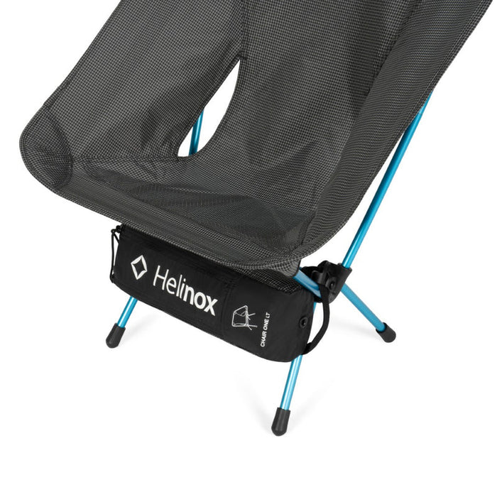 Black camping chair with blue legs and Helinox logo on a white background