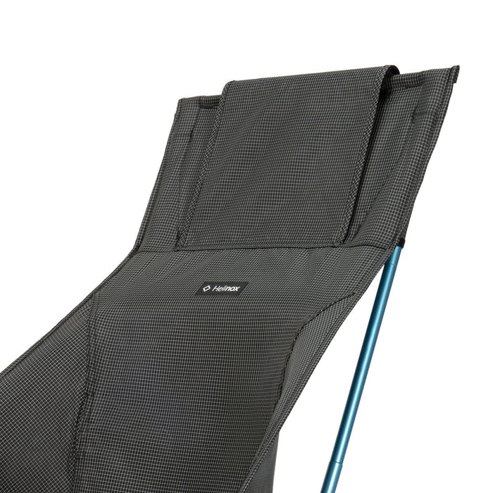 Black camping chair with mesh backrest and blue leg on a white background