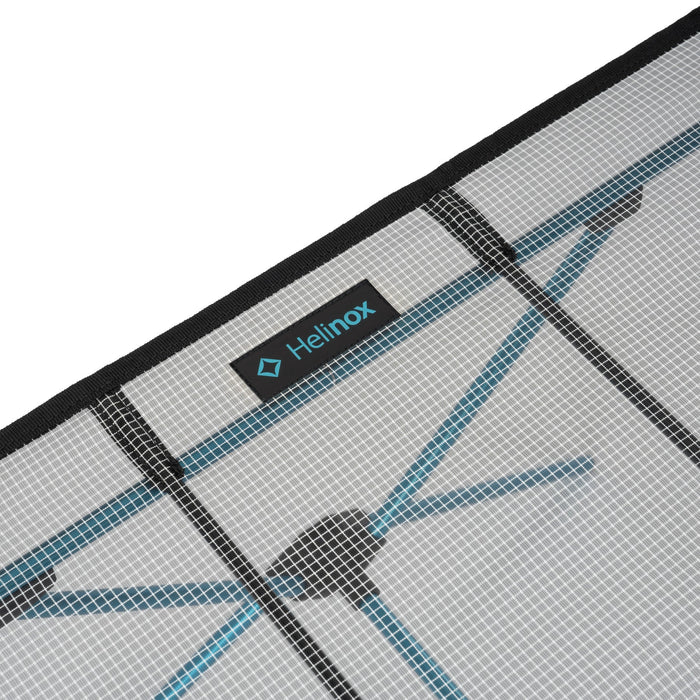 Close-up of ultralight Helinox Camping Table setup on a white background