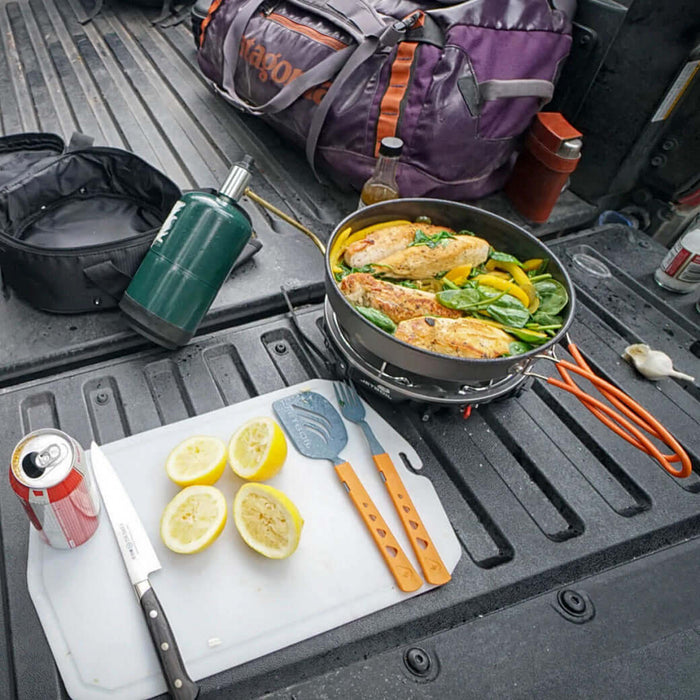 A Jetboild Halfgen Stove on the tailgate of a ute cooking lunch