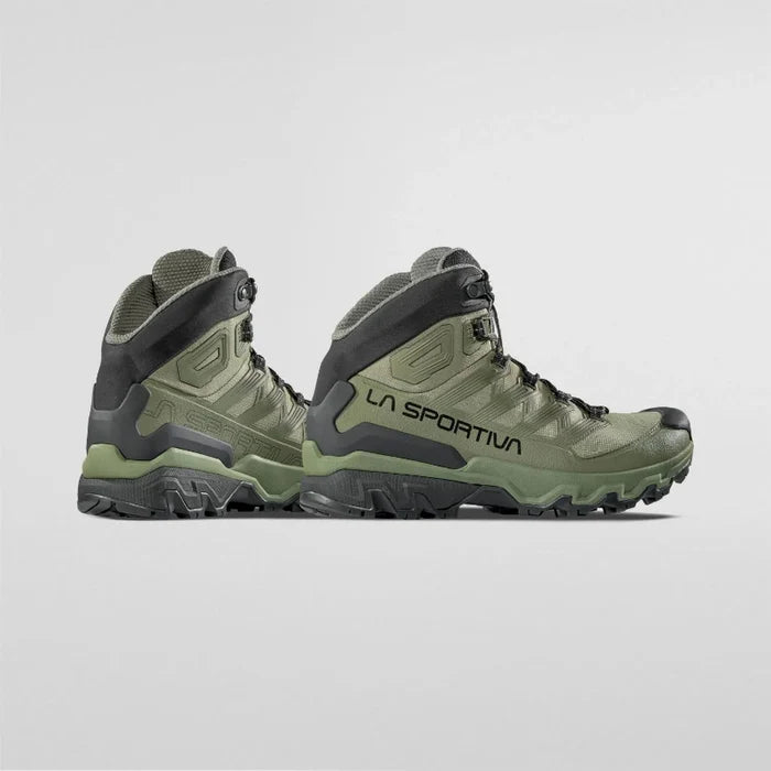 Green hiking boots with black accents on a light gray background