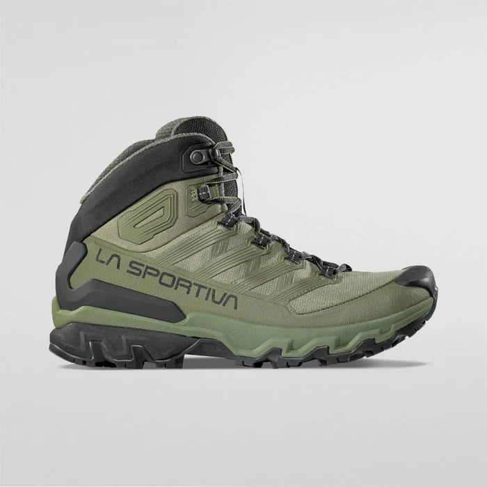 Green hiking boot with black accents on a light gray background