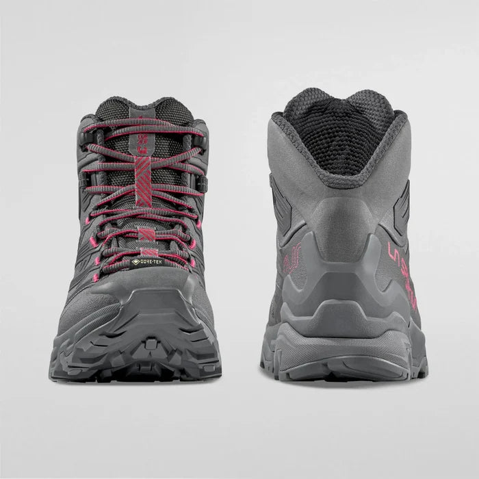 Pair of gray womens hiking hiking boots with red accents on a light gray background