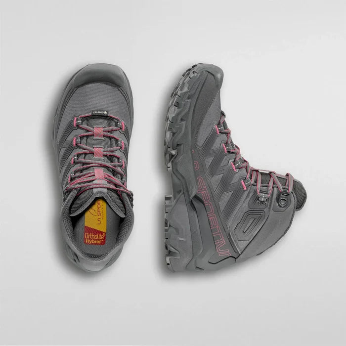Pair of gray La Sportiva womens hiking boots with pink laces on a light gray background