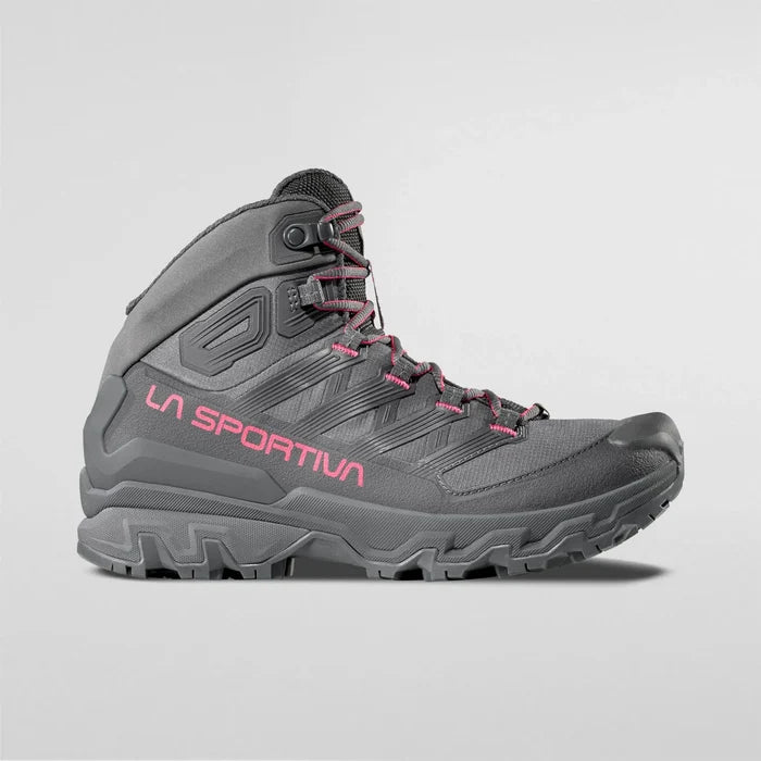 Gray La Sportiva waterproof Womens hiking boots with pink branding on a light gray background