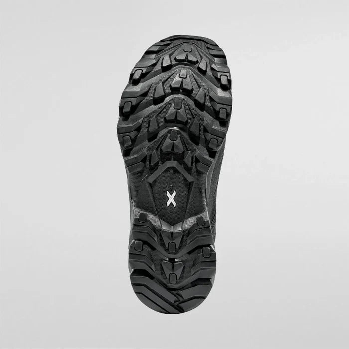 Close-up of a black hiking boot sole on a light gray background