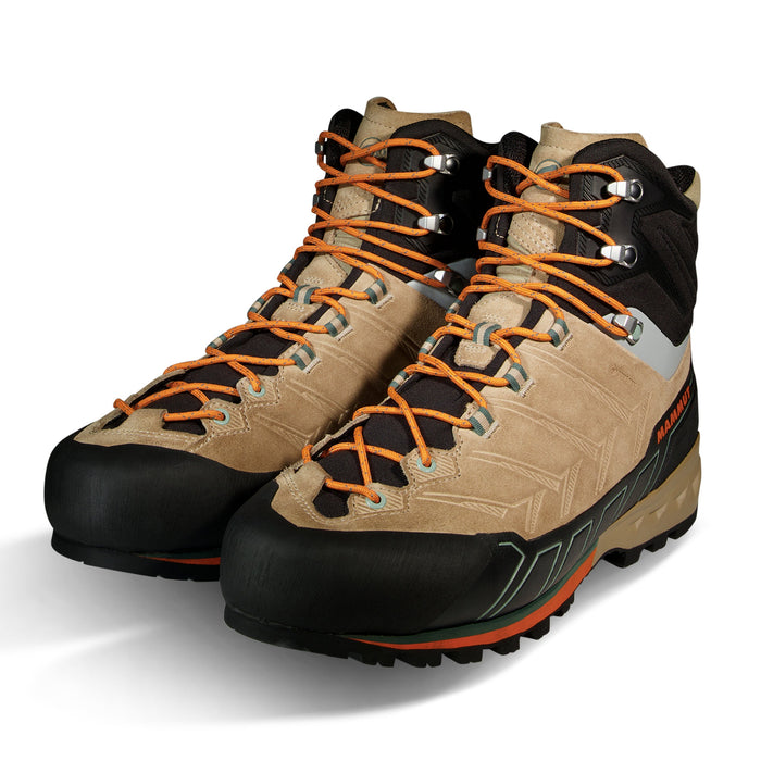 Pair of beige and black hiking boots with orange laces on a white background