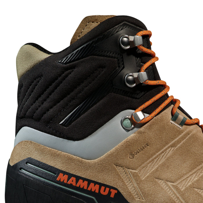 Close-up of a brown hiking boot with orange laces and Mammut branding on a white background