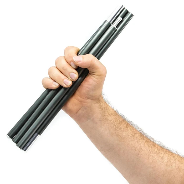Hand holding a set of black tarp poles against a white background