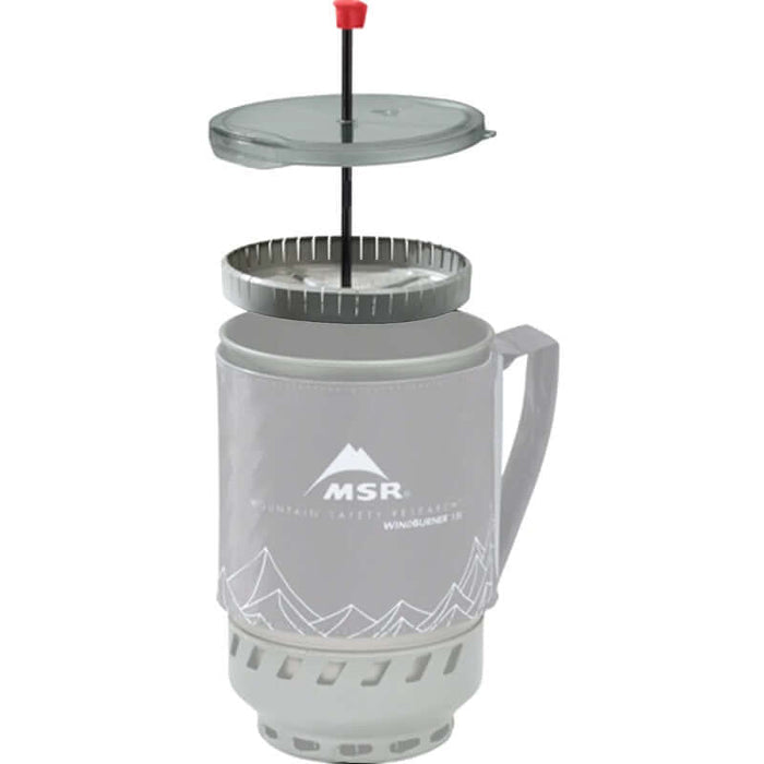 An MSR Coffee press on a windburner stove on a white backround