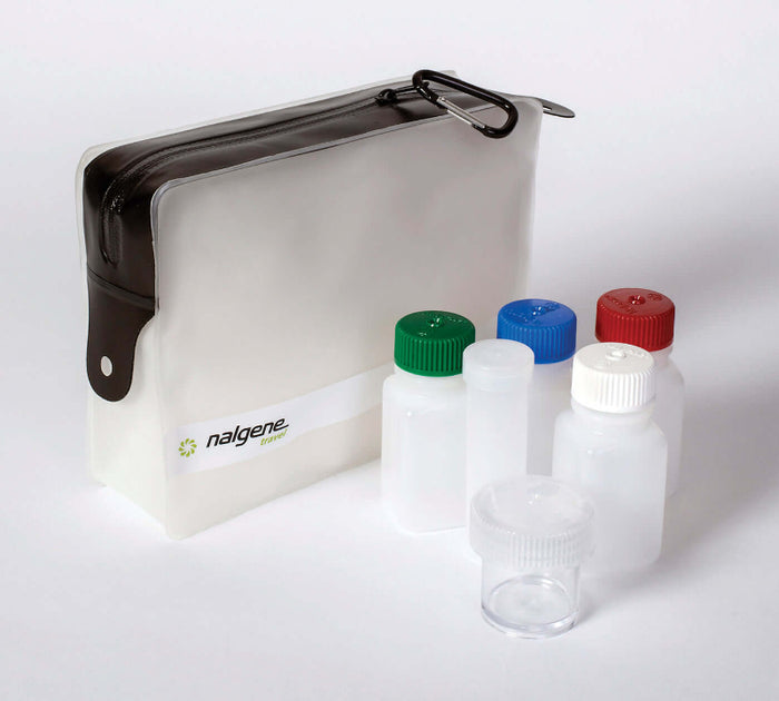 A Nalgene TSA Compliant 6 Piece Travel Kit with various leakproof bottles with different colored caps, a cotton swab vial, a straight sided jar, and a bag with a leak-resistant zipper.