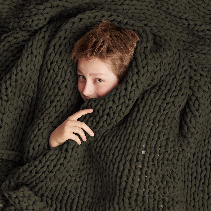 Kid wrapped in Bearaby Olive Night Nappling