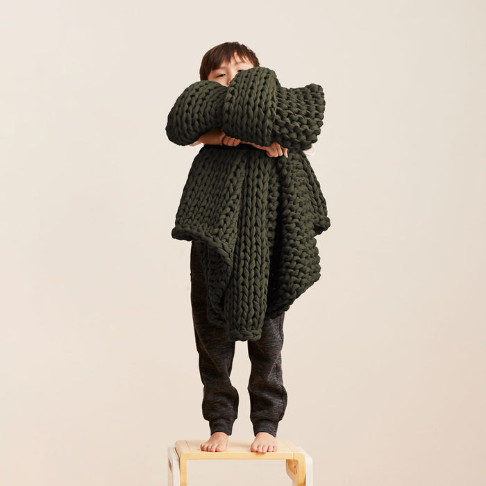 Kid holding Bearaby green color olive night children blanket