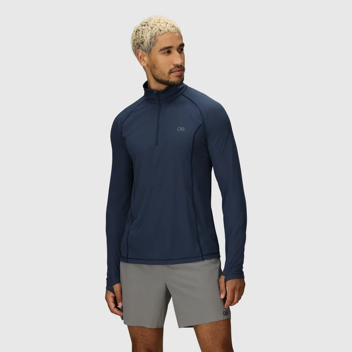 Man wearing a navy long-sleeve mens hiking top and gray trekking shorts on a light gray background