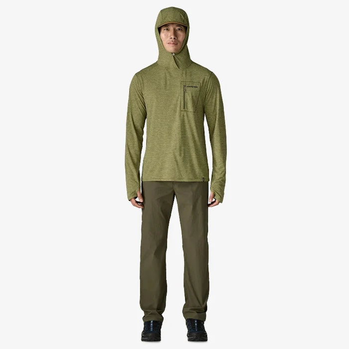 Man wearing the Patagonia Men’s Capilene Cool Sun Hoody Fitz Roy Trout with hood on in light green pants