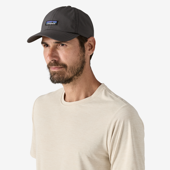 Man wearing the Patagonia Terrebone Cap Black in a white shirt