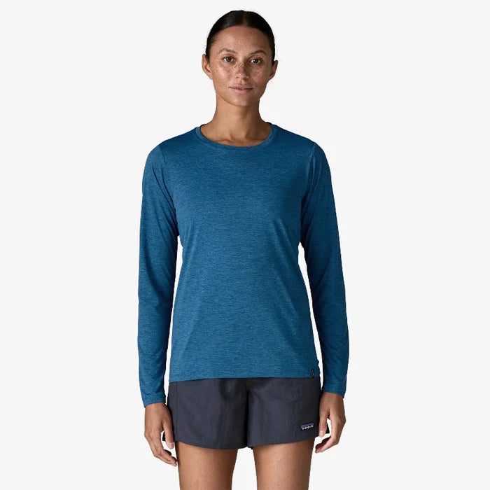 Woman wearing the aquatic blue patagonia women's long sleeve capilene cool daily shirt