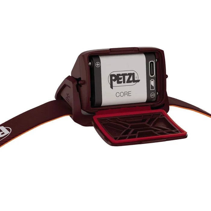 Petzl headlamp with open cover showing battery compartment on a white background