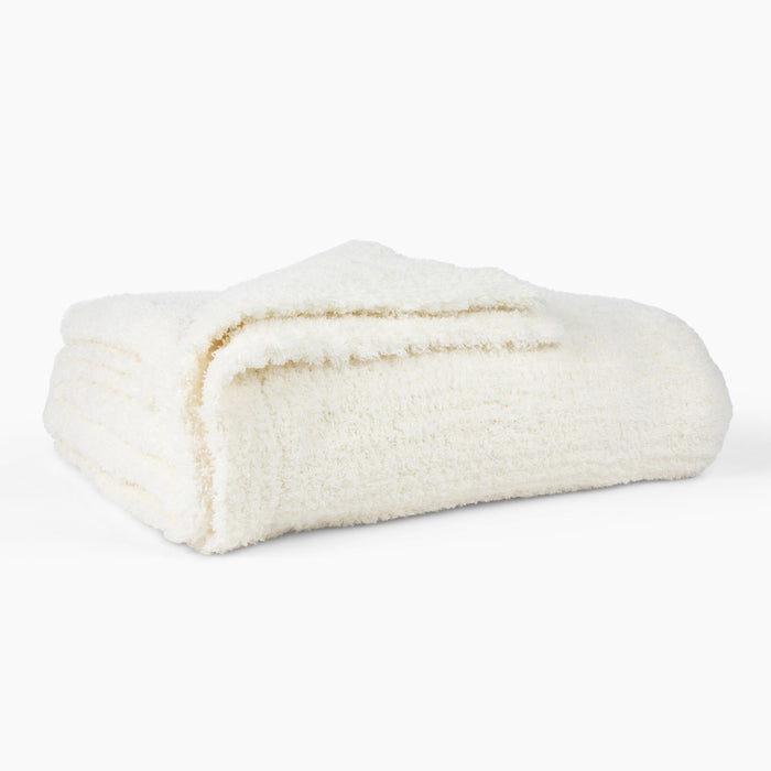folded white plush blanket