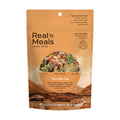 Real Meals freeze-dried Tom Kha Gai package with mountain and village background