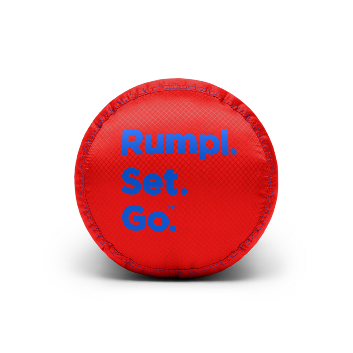 A red circular textured ball with blue text reading 'Rumpl. Set. Go.' on a clean white background.