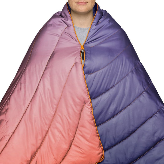 Person wrapped in a two-tone pink and purple sleeping bag on a white background