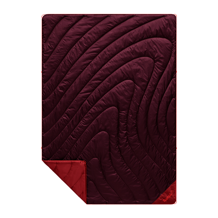 Maroon quilt with wavy pattern on a white background