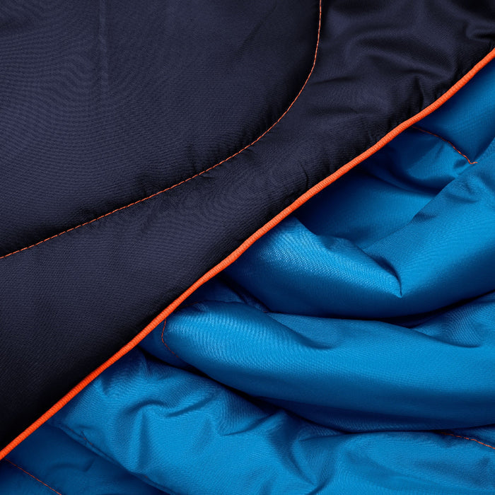 Close-up of a puffy sleeping bag showing a dark navy exterior panel with bright orange stitching, layered over a bright blue quilted interior.