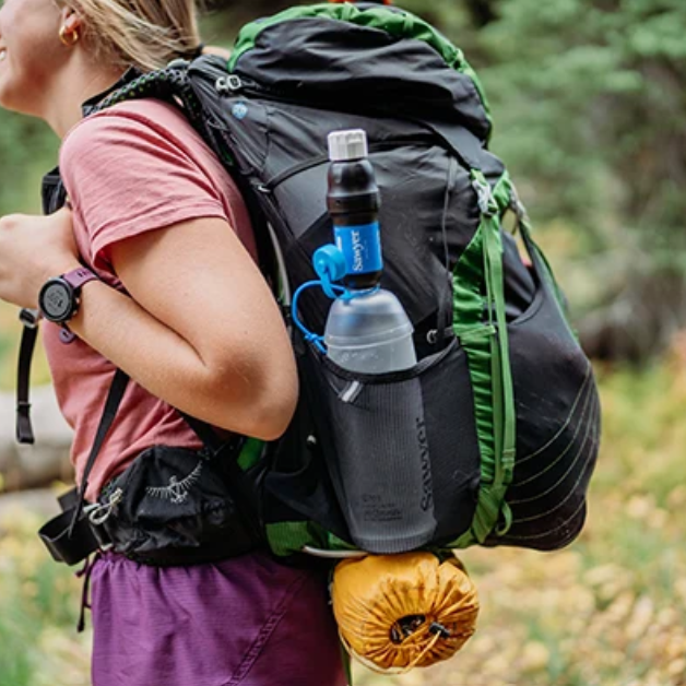 Sawyer Squeeze Water Filtration System w/ Cnoc 1L Bottle in a pack side pocket