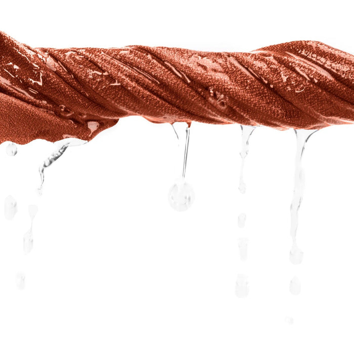 Close-up of a copper towel with water droplets on a white background