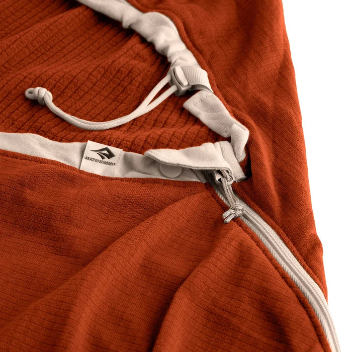 Close-up of a rust-colored jacket with white drawstrings and zipper on a white background