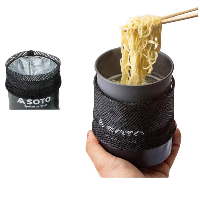 Person holding a portable cup with noodles and a black container labeled 'SOTO'.