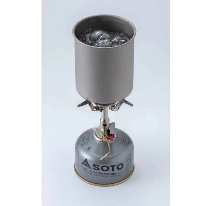 Portable gas stove with a fuel canister on a light gray background